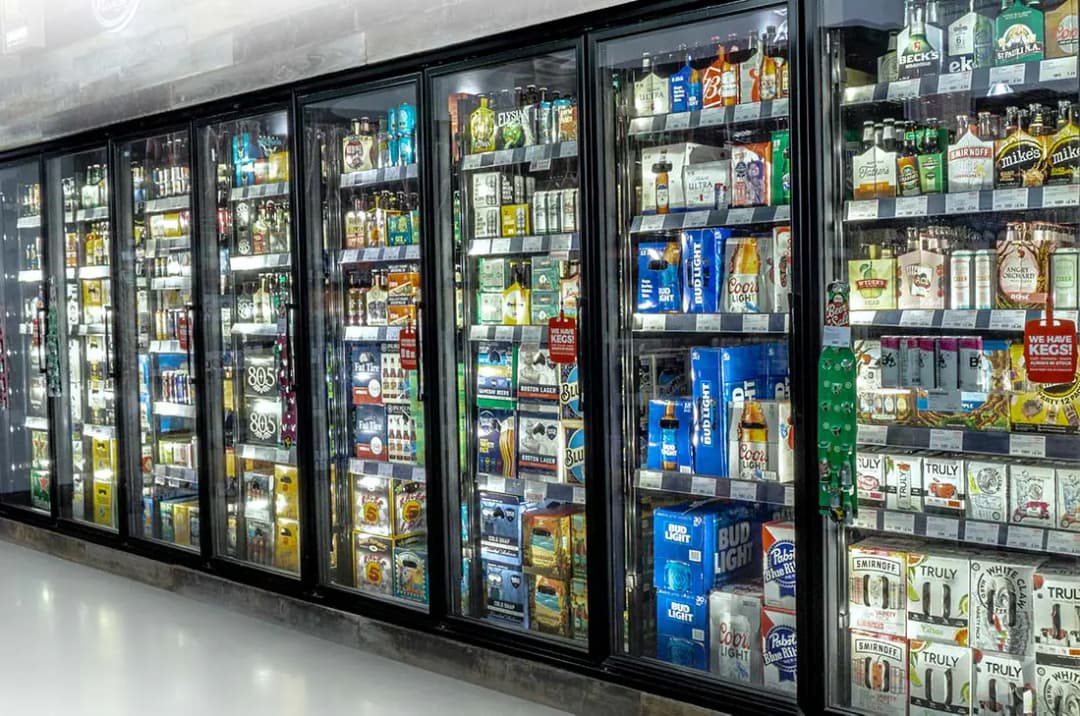 Anthony glass display doors installed on a convenience store walk-in beverage cooler
