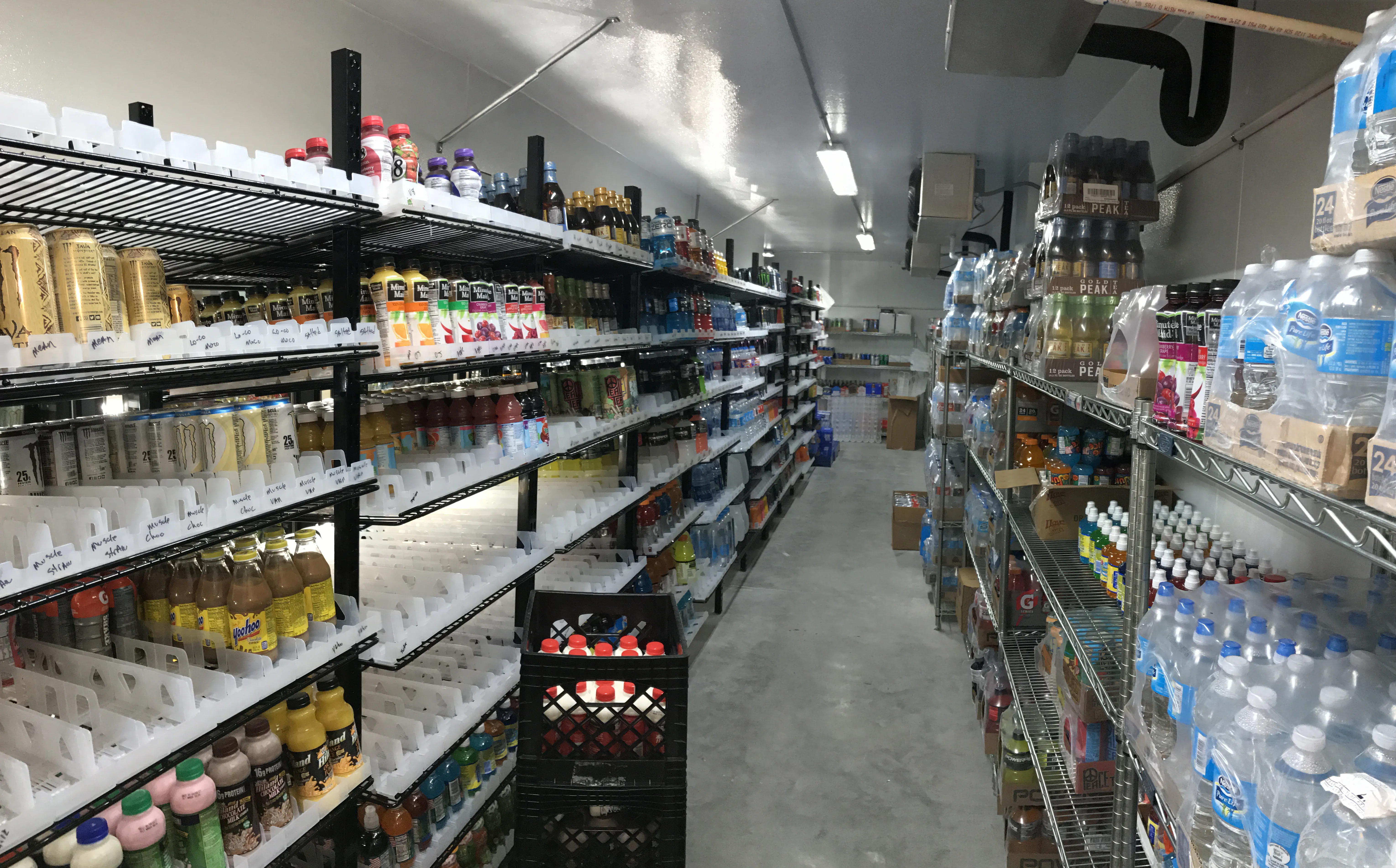 Walk in cooler backstock shelving in a convenience store